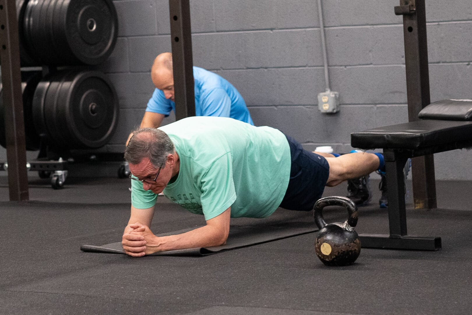 Man doing a plank exercise at TREBEL Wellness
